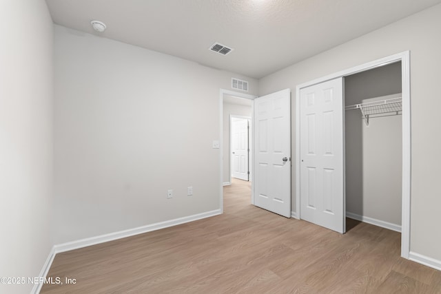 8077 Devoe St, Jacksonville, FL 32220 - unfurnished bedroom featuring light wood-style flooring and a closet
