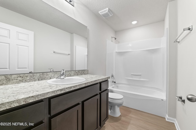 8077 Devoe St, Jacksonville, FL 32220 - full bathroom with vanity, wood finished floors, bathtub / shower combination, and a textured ceiling