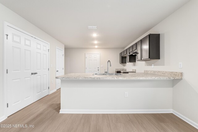 8077 Devoe St, Jacksonville, FL 32220 - kitchen featuring light countertops, a peninsula, and light wood finished floors