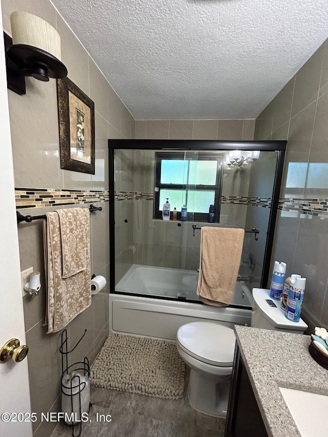 2788 SW 46th Ct, Fort Lauderdale, FL 33312 - bathroom featuring a textured ceiling, vanity, enclosed tub / shower combo, and tile walls