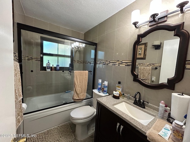 2788 SW 46th Ct, Fort Lauderdale, FL 33312 - bathroom with a textured ceiling, vanity, tile walls, and shower / bath combination with glass door