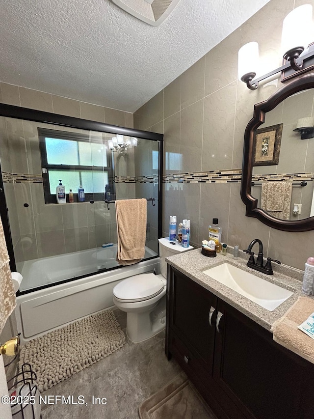 2788 SW 46th Ct, Fort Lauderdale, FL 33312 - bathroom with vanity, tile walls, shower / bath combination with glass door, and a textured ceiling