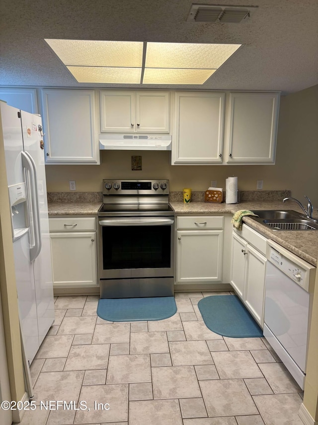4250 A1A Unit R19, Saint Augustine, FL 32080 - kitchen with white appliances, under cabinet range hood, and light countertops