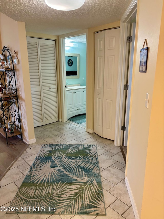 4250 A1A Unit R19, Saint Augustine, FL 32080 - hall featuring light tile patterned floors and a textured ceiling