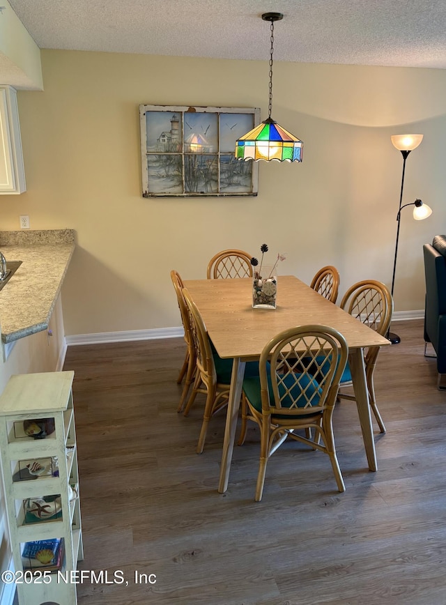 4250 A1A Unit R19, Saint Augustine, FL 32080 - dining space featuring dark wood-type flooring and a textured ceiling