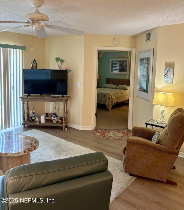 4250 A1A Unit R19, Saint Augustine, FL 32080 - living area with a ceiling fan, wood finished floors, and a textured ceiling
