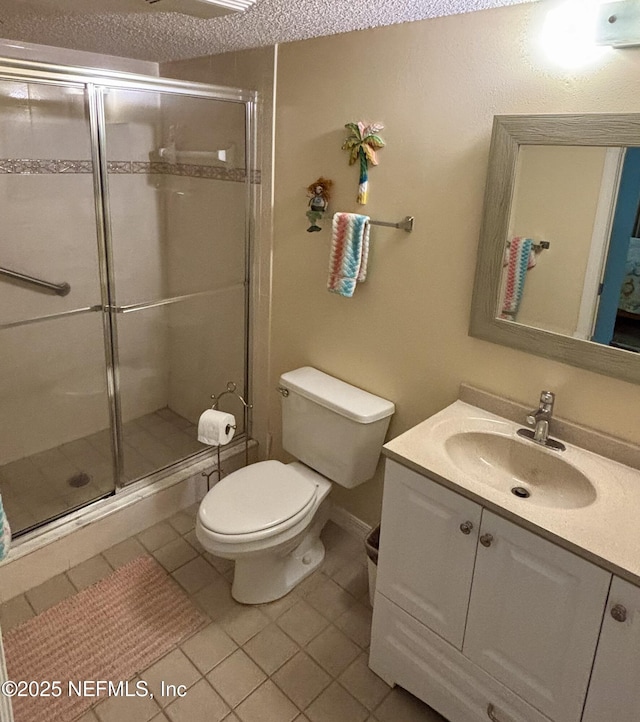 4250 A1A Unit R19, Saint Augustine, FL 32080 - bathroom with vanity, tile patterned flooring, a shower stall, and a textured ceiling