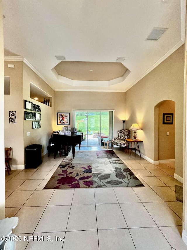 16325 Magnolia Bluff Dr, Montverde, FL 34756 - playroom with ornamental molding, tile patterned flooring, a raised ceiling, and arched walkways