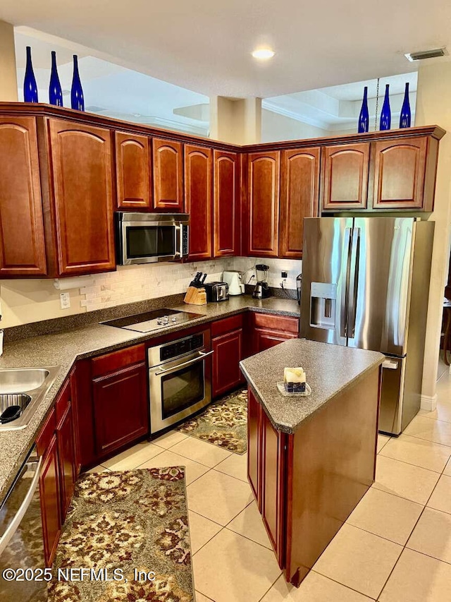 16325 Magnolia Bluff Dr, Montverde, FL 34756 - kitchen with appliances with stainless steel finishes, dark brown cabinets, light tile patterned flooring, and dark countertops