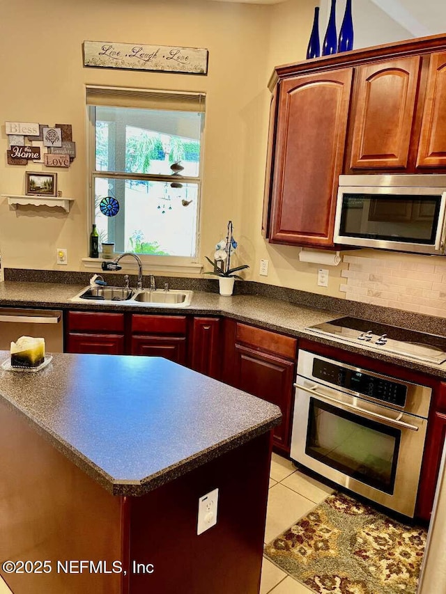 16325 Magnolia Bluff Dr, Montverde, FL 34756 - kitchen with stainless steel appliances, dark countertops, light tile patterned flooring, dark brown cabinets, and decorative backsplash