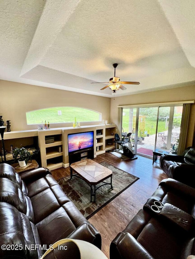 16325 Magnolia Bluff Dr, Montverde, FL 34756 - living area featuring a textured ceiling, wood finished floors, and a ceiling fan