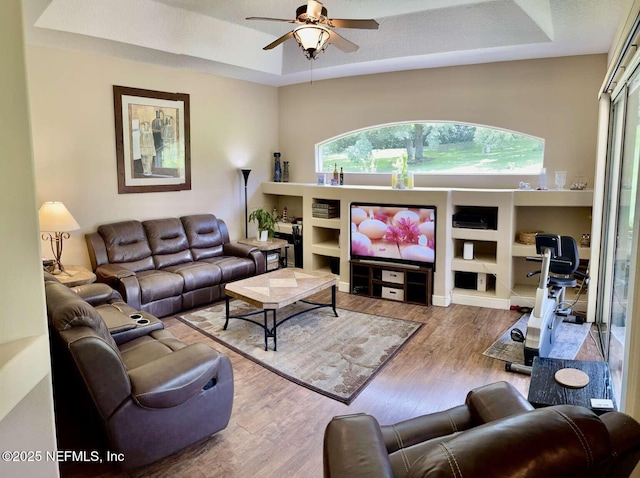 16325 Magnolia Bluff Dr, Montverde, FL 34756 - living room with a tray ceiling, a ceiling fan, and wood finished floors