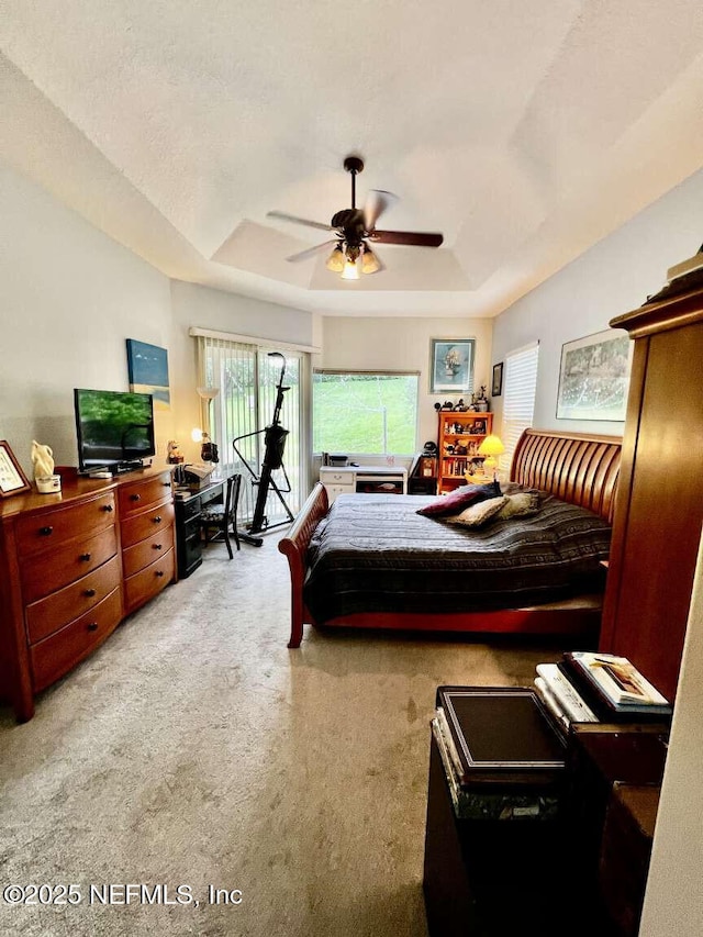 16325 Magnolia Bluff Dr, Montverde, FL 34756 - carpeted bedroom featuring a raised ceiling and ceiling fan
