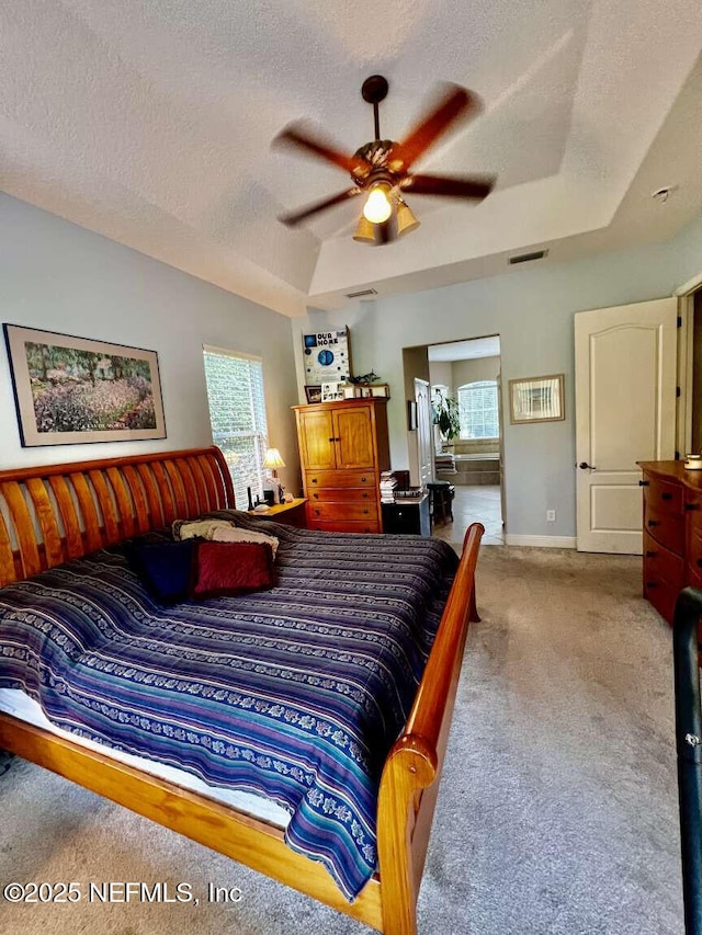 16325 Magnolia Bluff Dr, Montverde, FL 34756 - carpeted bedroom featuring a raised ceiling, a textured ceiling, and ceiling fan