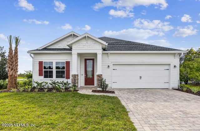 2769 Seasons Rd, Green Cove Springs, FL 32043 - view of front of house featuring a garage, decorative driveway, a front lawn, and a shingled roof