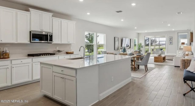 2769 Seasons Rd, Green Cove Springs, FL 32043 - kitchen with open floor plan, plenty of natural light, recessed lighting, stainless steel microwave, and light countertops