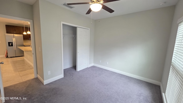 228 Clayton St, Brandon, FL 33511 - unfurnished bedroom with stainless steel refrigerator with ice dispenser, light colored carpet, a closet, and a ceiling fan