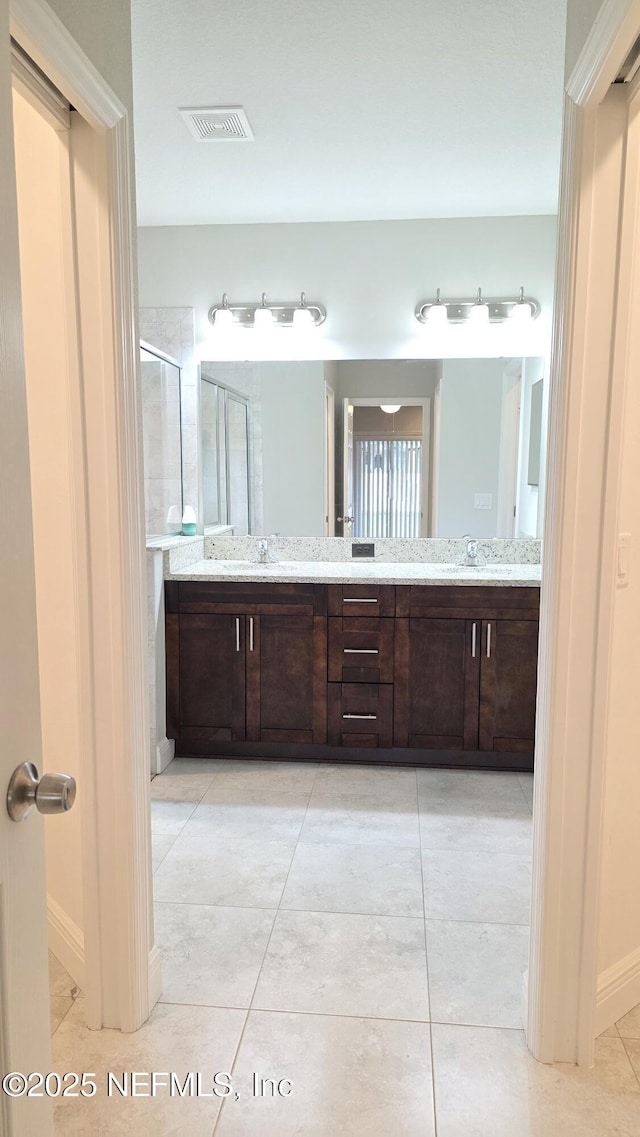 228 Clayton St, Brandon, FL 33511 - full bath with double vanity, a stall shower, and tile patterned floors