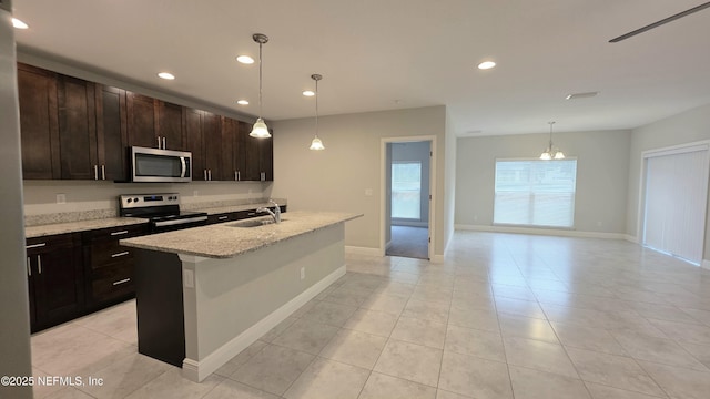 228 Clayton St, Brandon, FL 33511 - kitchen featuring range with electric cooktop, stainless steel microwave, a chandelier, recessed lighting, and light tile patterned floors