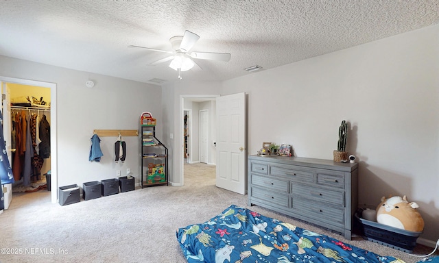 1361 Wekiva Way, Saint Augustine, FL 32092 - bedroom featuring carpet floors, a spacious closet, a ceiling fan, and a textured ceiling