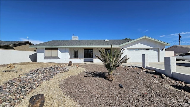 ranch-style home with concrete driveway, fence, an attached garage, and stucco siding