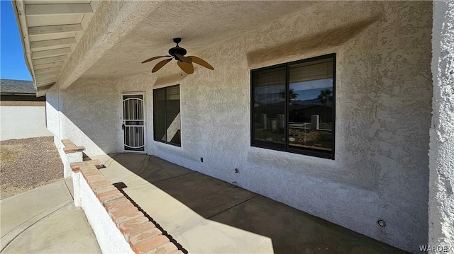 view of patio featuring ceiling fan