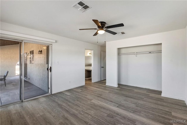 unfurnished bedroom featuring baseboards, visible vents, ceiling fan, dark wood-type flooring, and a closet