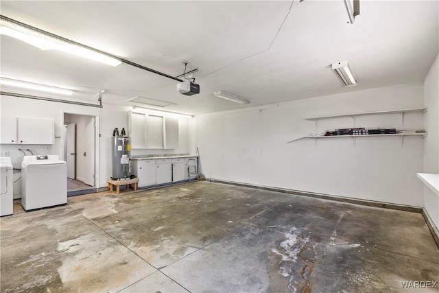 garage with independent washer and dryer, a garage door opener, and electric water heater