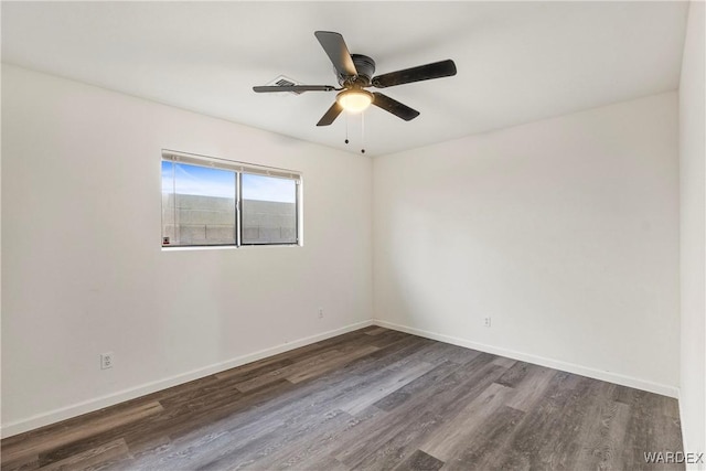 unfurnished room with dark wood-style floors, baseboards, and a ceiling fan