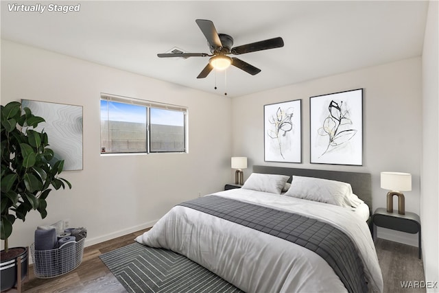 bedroom with dark wood-type flooring, baseboards, and a ceiling fan