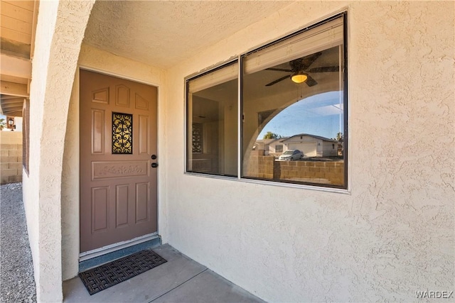 entrance to property with stucco siding