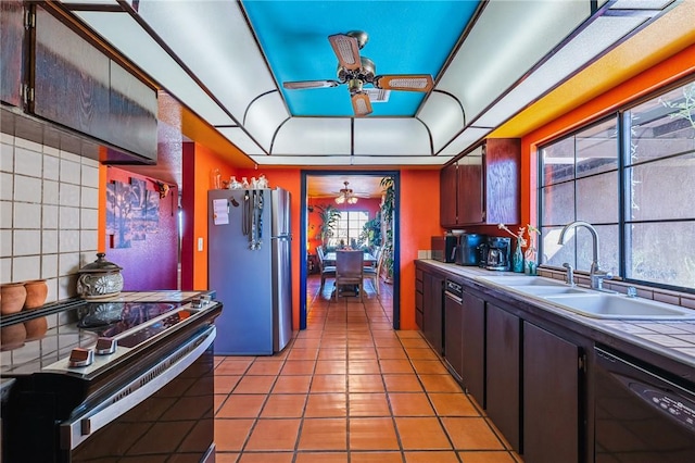4390 El Camino Rd, Bullhead City, AZ 86429 - kitchen with black dishwasher, freestanding refrigerator, a ceiling fan, electric stove, and light tile patterned flooring