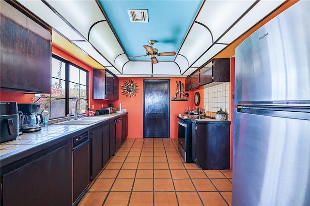 4390 El Camino Rd, Bullhead City, AZ 86429 - kitchen featuring freestanding refrigerator, tile countertops, range with gas cooktop, ceiling fan, and black dishwasher