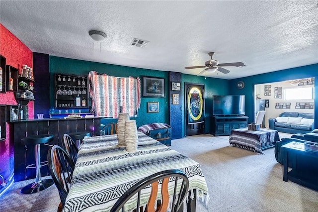 4390 El Camino Rd, Bullhead City, AZ 86429 - living area featuring a textured ceiling, carpet floors, a dry bar, and a ceiling fan