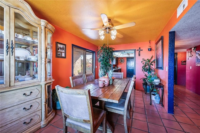 4390 El Camino Rd, Bullhead City, AZ 86429 - tiled dining area with ceiling fan and a textured ceiling