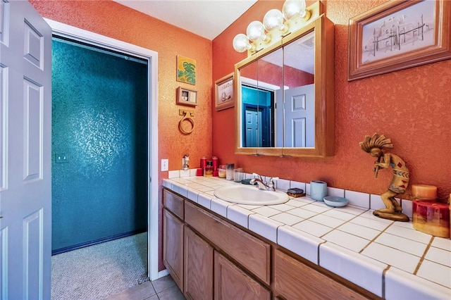 4390 El Camino Rd, Bullhead City, AZ 86429 - bathroom featuring vanity, tile patterned floors, and a textured wall