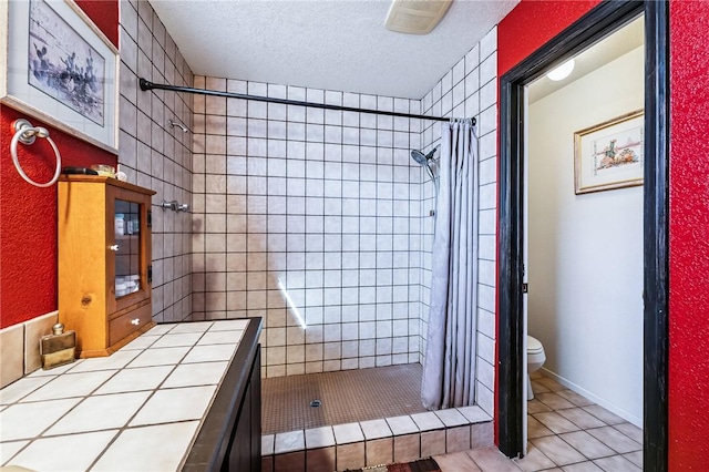 4390 El Camino Rd, Bullhead City, AZ 86429 - full bathroom featuring a shower stall, tile patterned floors, and a textured ceiling
