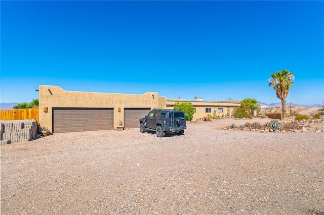 4390 El Camino Rd, Bullhead City, AZ 86429 - pueblo-style house featuring driveway, stucco siding, and an attached garage