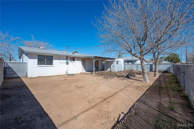 back of property featuring a fenced backyard and brick siding