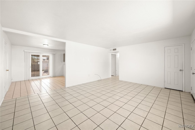 unfurnished room featuring light tile patterned floors and visible vents