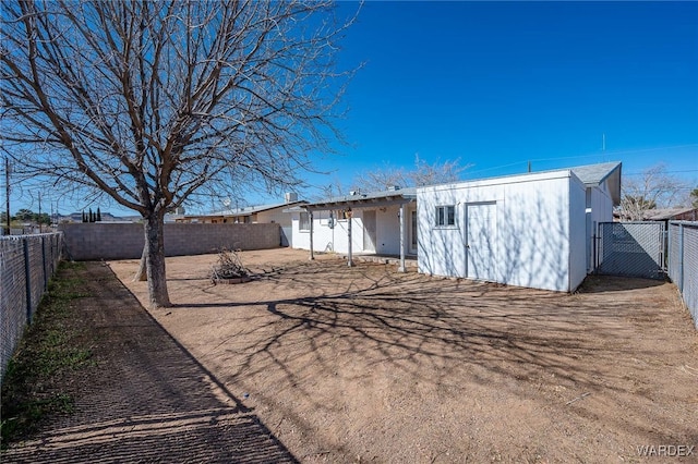 rear view of property with a fenced backyard