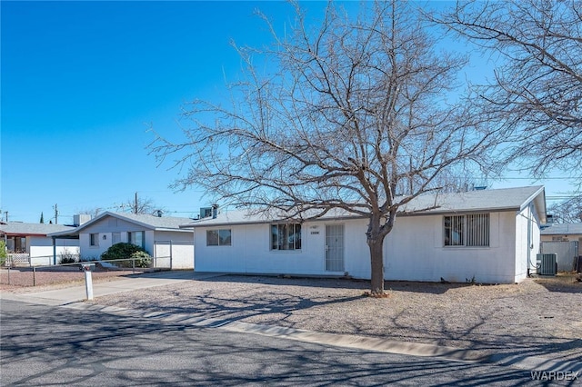 ranch-style house featuring central AC, fence, and driveway