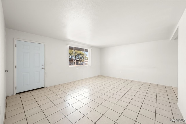 spare room featuring light tile patterned flooring