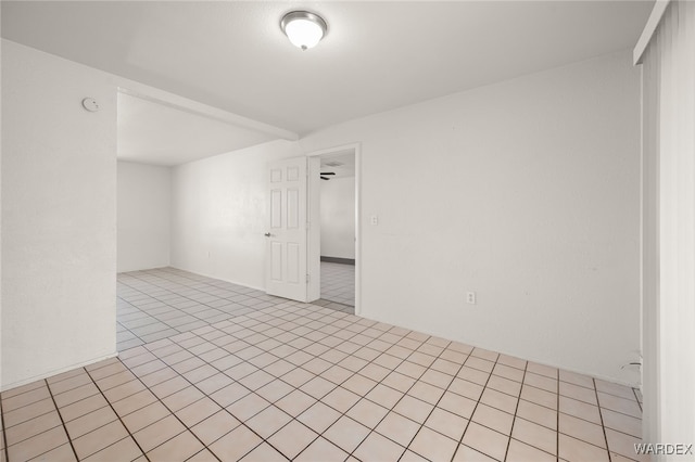 unfurnished room featuring light tile patterned floors