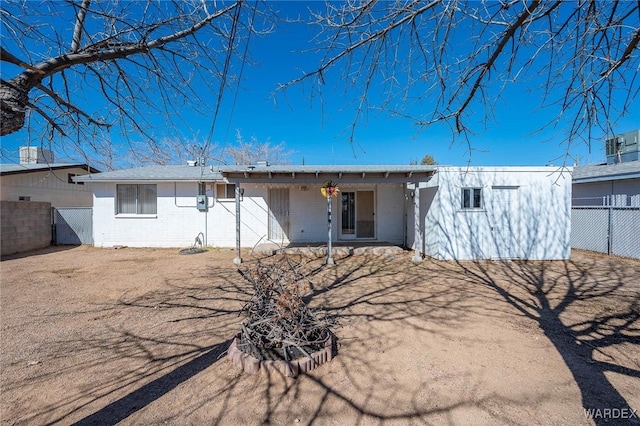 back of house with fence