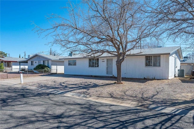 single story home with central air condition unit, driveway, and fence