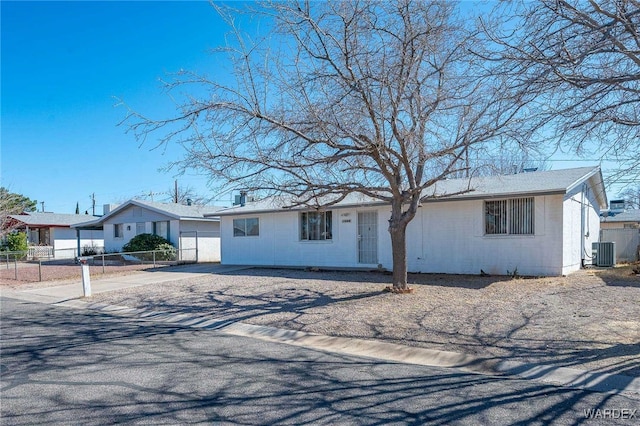 ranch-style home with central air condition unit and fence