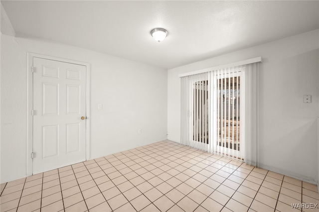 unfurnished room featuring light tile patterned floors