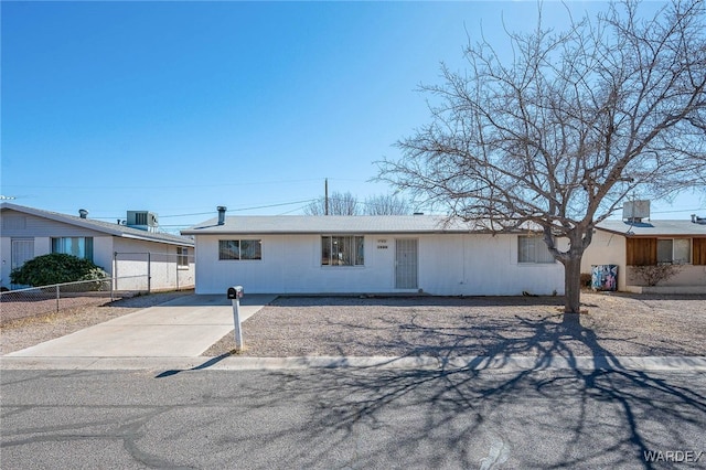 view of front of house featuring central AC unit and fence