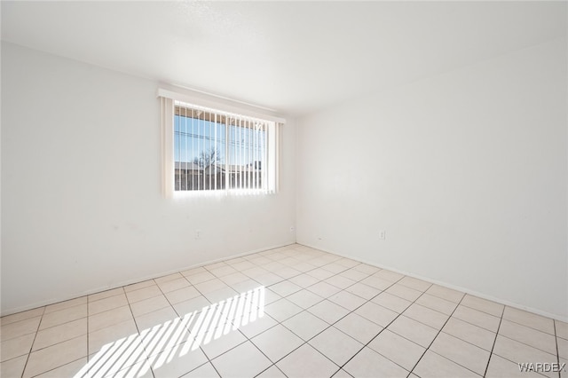 unfurnished room with light tile patterned floors